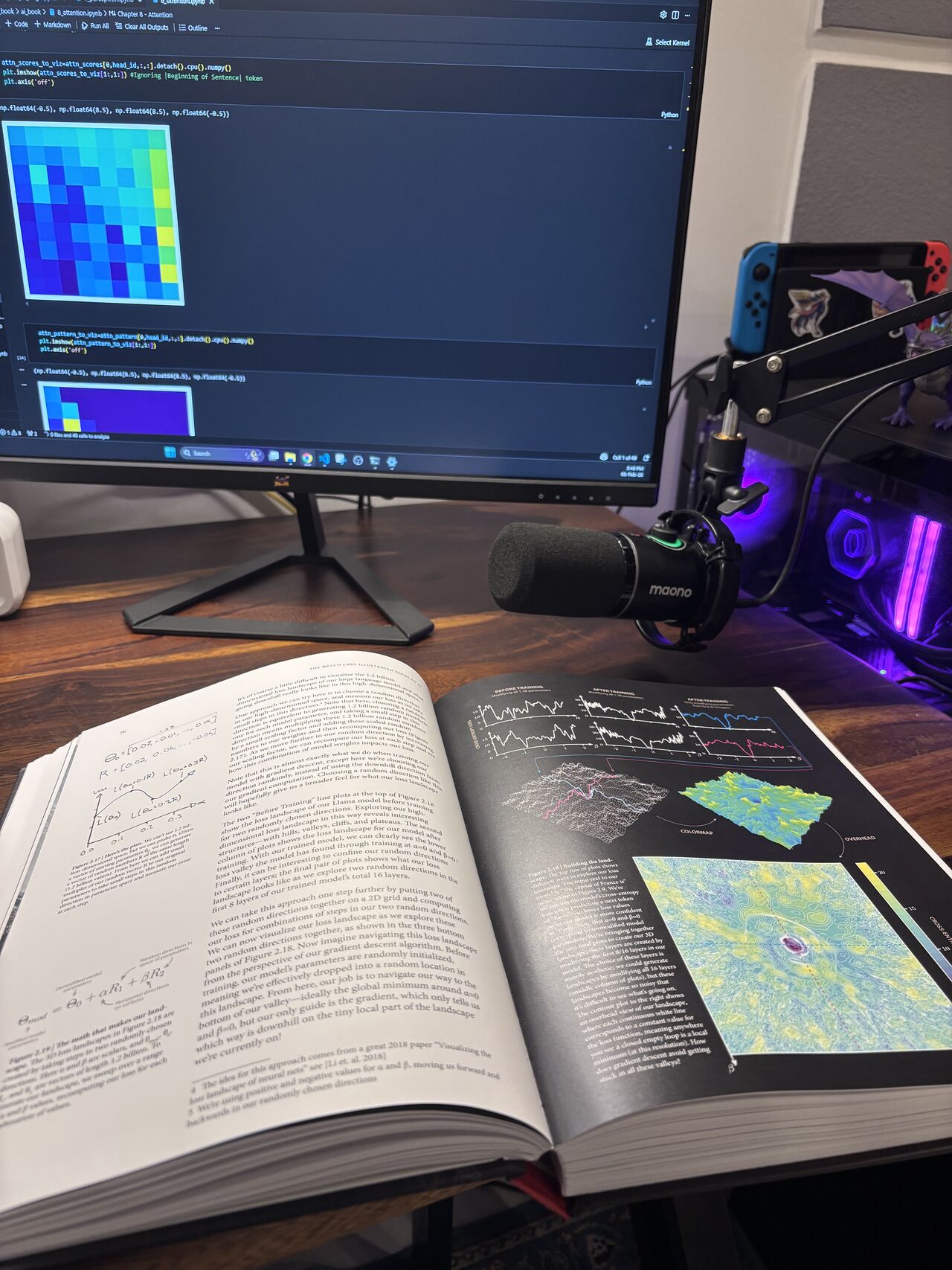 Khoa’s study desk with an open technical book, handwritten notes, and code and model visualizations on the monitor.